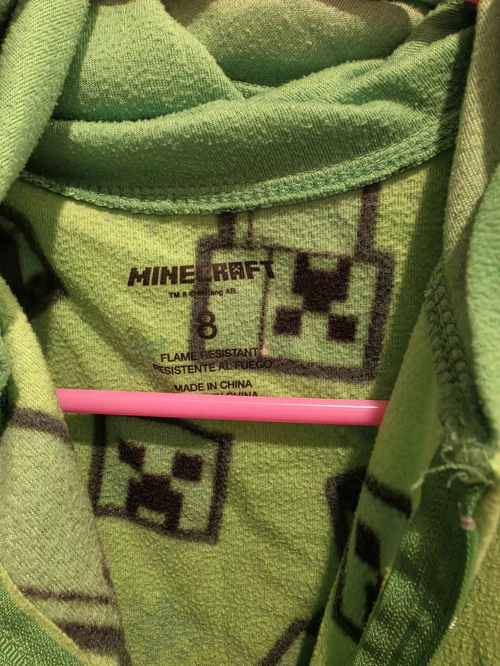 Green Minecraft Creeper onesie with black Creeper faces